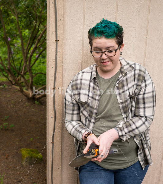 Diverse Gardening Stock Photo: Agender Person Holds Hand Tools - Body Liberation Photos