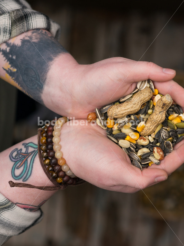 Diverse Gardening Stock Photo: Agender Person Holds Nuts and Seeds - Body Liberation Photos