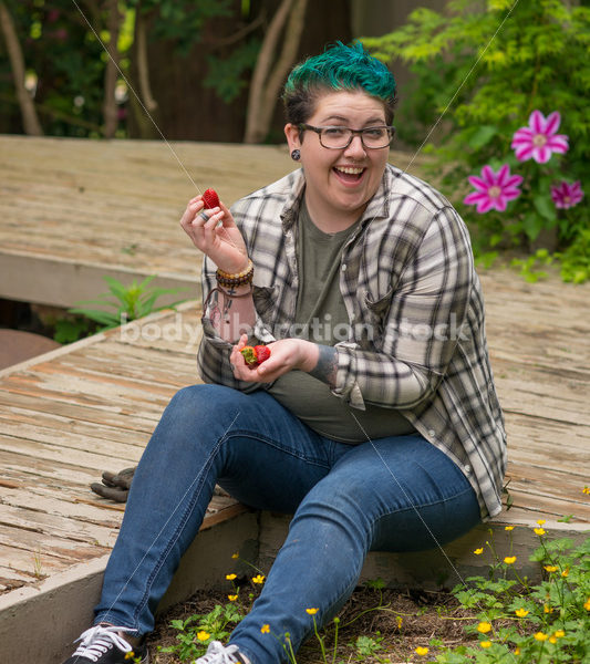 Diverse Gardening Stock Photo: Agender Person Picks Strawberries - Body Liberation Photos