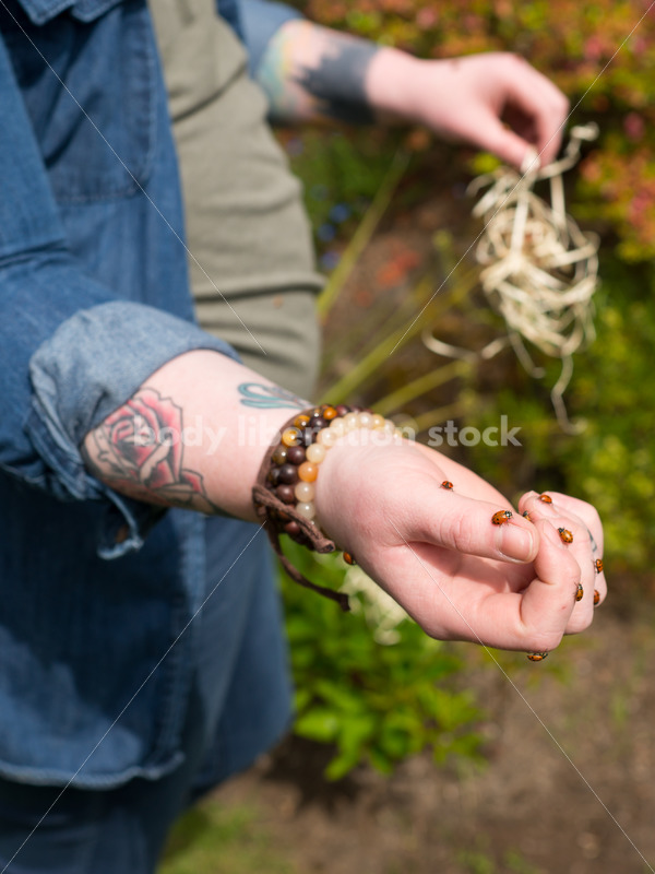 Diverse Gardening Stock Photo: Agender Person Releases Ladybugs in Garden - Body Liberation Photos