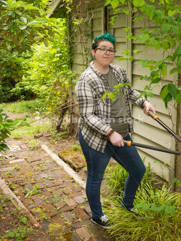 Diverse Gardening Stock Photo: Agender Person Trims Vine - Body Liberation Photos