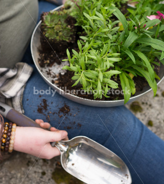 Diverse Gardening Stock Photo: Agender Person with Trowel and Seedlings - Body Liberation Photos