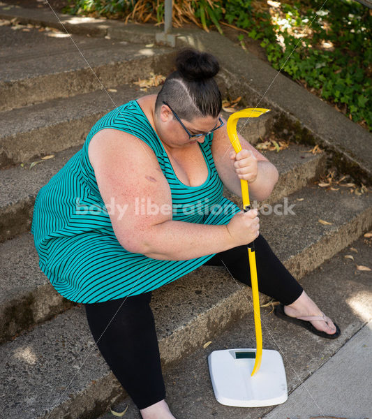 Eating Disorder Recovery Stock Image: Woman Smashing Bathroom Scale - Body Liberation Photos