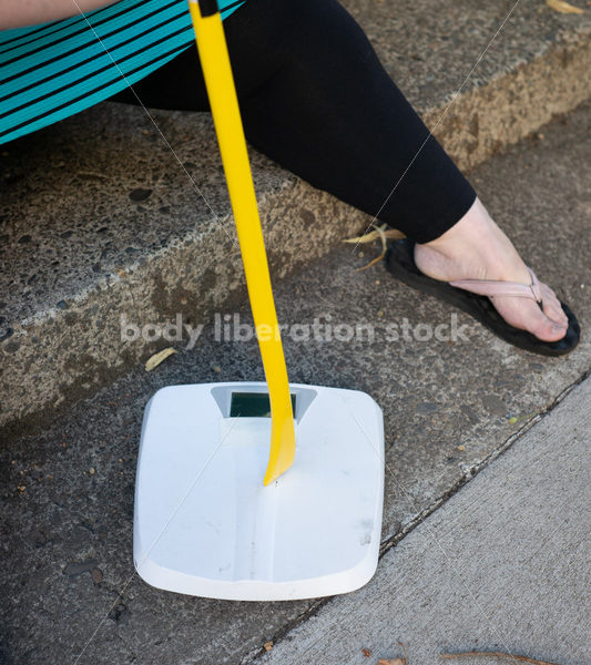 Eating Disorder Recovery Stock Image: Woman Smashing Bathroom Scale - Body Liberation Photos