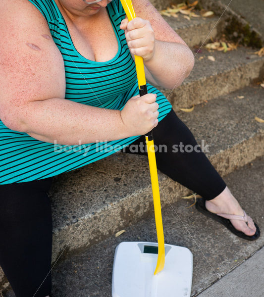 Eating Disorder Recovery Stock Image: Woman Smashing Bathroom Scale - Body Liberation Photos