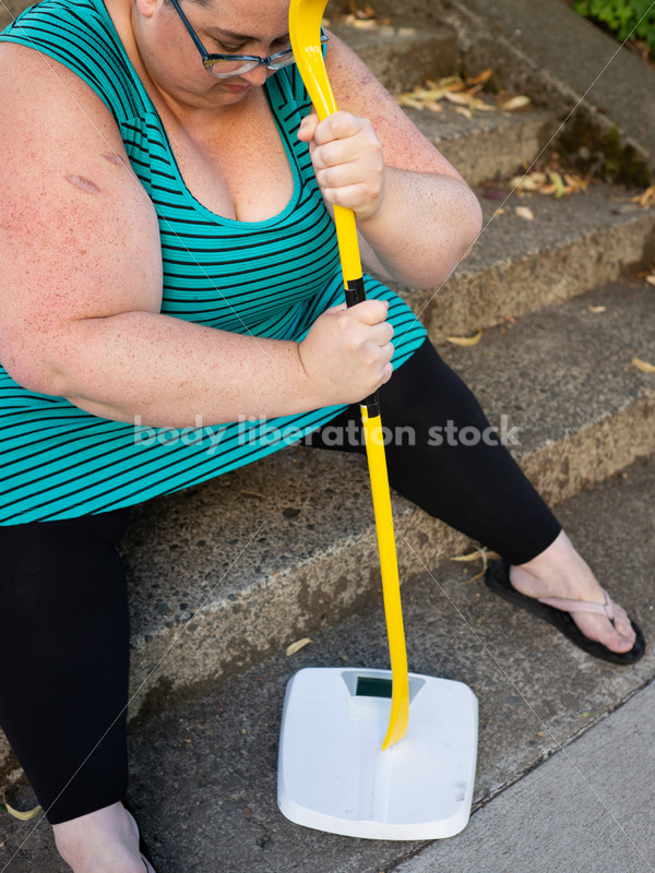 Eating Disorder Recovery Stock Image: Woman Smashing Bathroom Scale - Body Liberation Photos