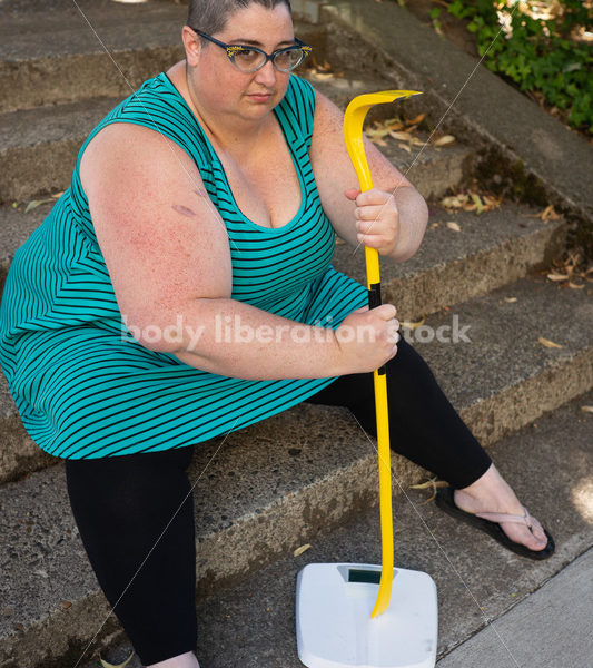 Eating Disorder Recovery Stock Image: Woman Smashing Bathroom Scale - Body Liberation Photos