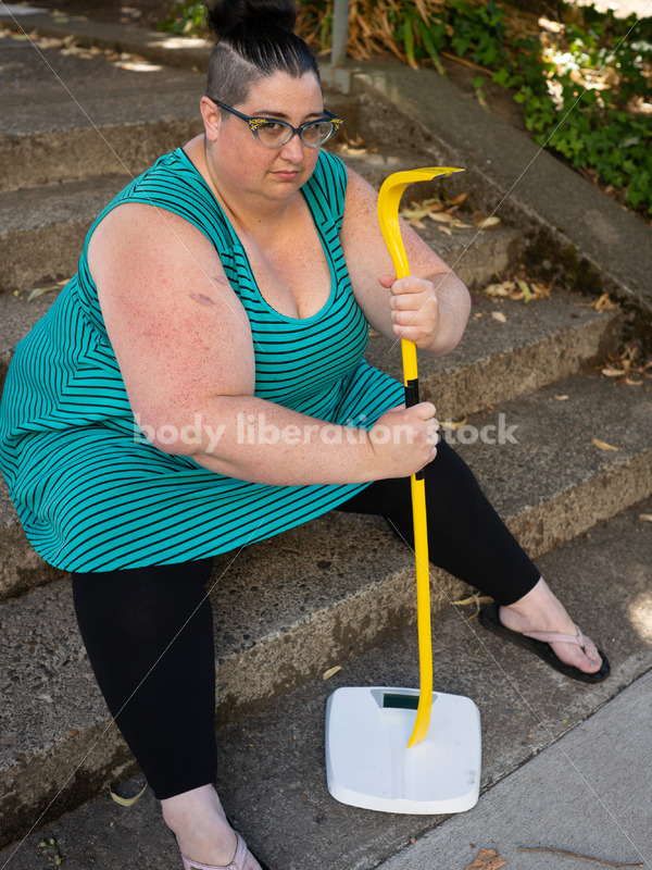 Eating Disorder Recovery Stock Image: Woman Smashing Bathroom Scale - Body Liberation Photos