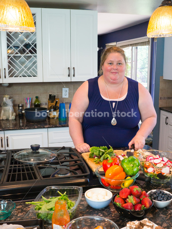 Eating Disorder Recovery Stock Photo: Woman Chopping Peppers on Kitchen Counter - Body Liberation Photos