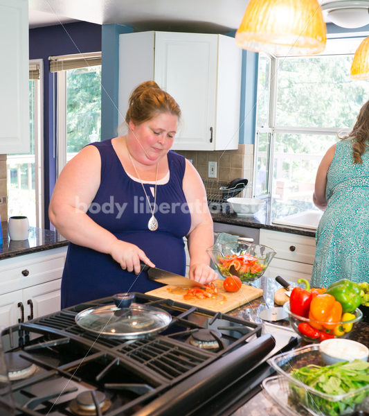 Eating Disorder Recovery Stock Photo: Woman Chops Vegetables in Kitchen - Body Liberation Photos