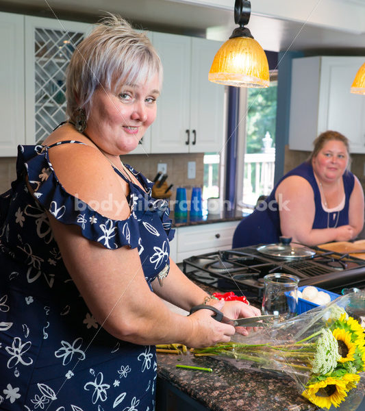 Eating Disorder Recovery Stock Photo: Woman Cuts Flowers in Kitchen - Body Liberation Photos