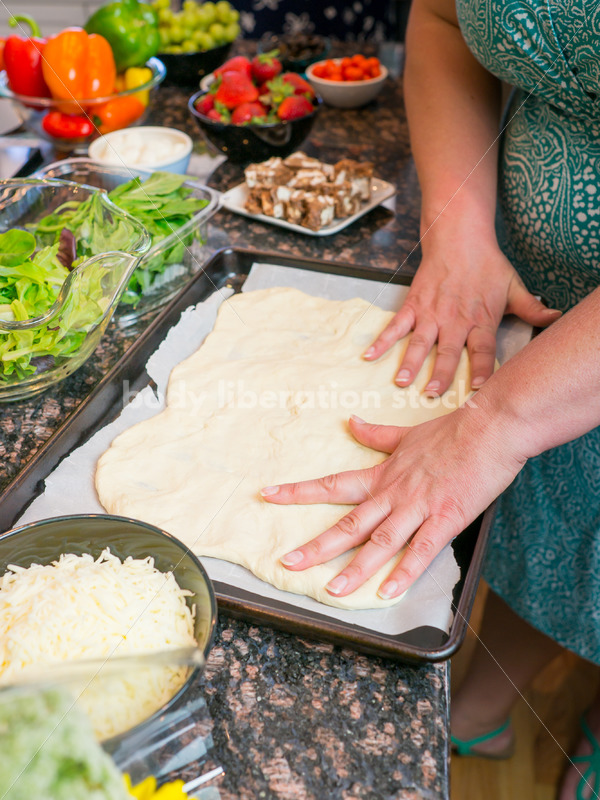 Eating Disorder Recovery Stock Photo: Woman Preparing Pizza Dough in Kitchen - Body Liberation Photos