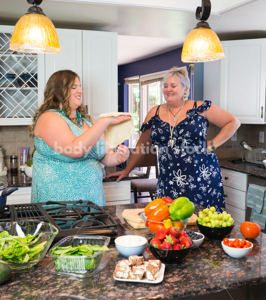 Eating Disorder Recovery Stock Photo: Woman Tossing Pizza Dough in Kitchen - Body Liberation Photos