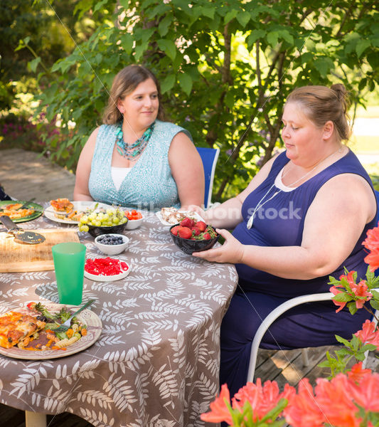 Intuitive Eating Stock Image: Woman Chooses Foods During Outdoor Meal - Body Liberation Photos