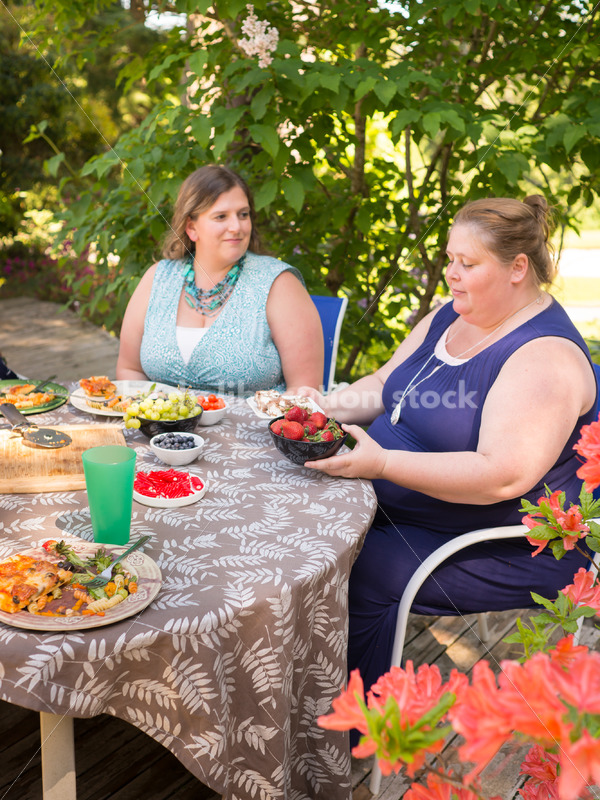 Intuitive Eating Stock Image: Woman Chooses Foods During Outdoor Meal - Body Liberation Photos