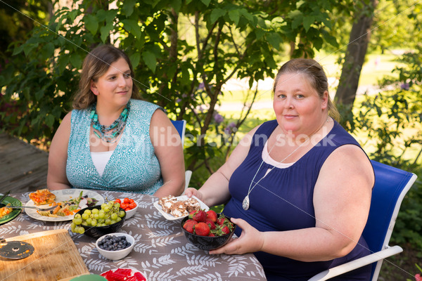 Intuitive Eating Stock Image: Woman Chooses Foods During Outdoor Meal - Body Liberation Photos