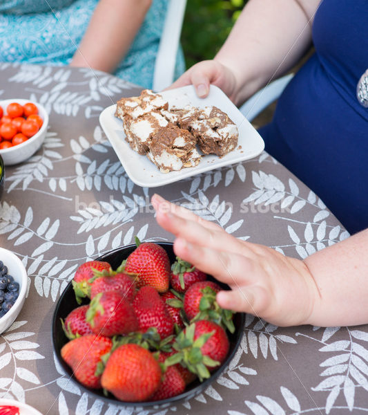 Intuitive Eating Stock Image: Woman Chooses Foods During Outdoor Meal - Body Liberation Photos