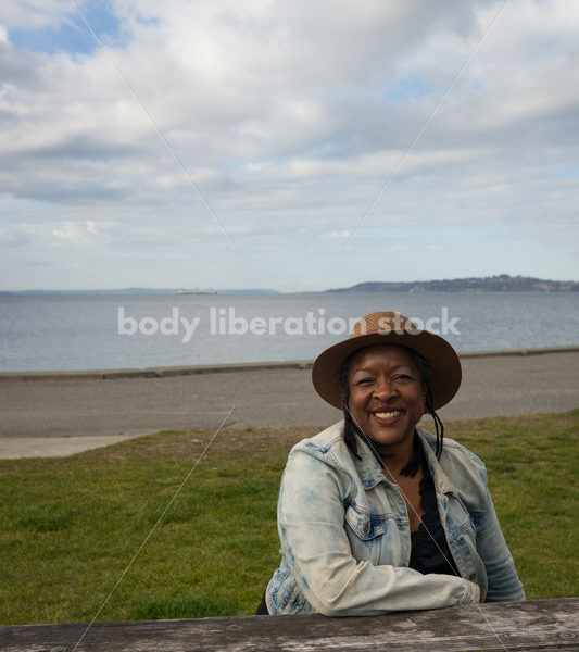 Plus-Size African American Woman Outdoors Relaxing at Picnic Table - Body Liberation Photos