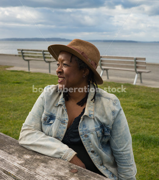 Plus-Size African American Woman Outdoors Relaxing at Picnic Table - Body Liberation Photos