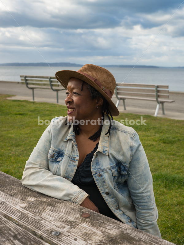 Plus-Size African American Woman Outdoors Relaxing at Picnic Table - Body Liberation Photos