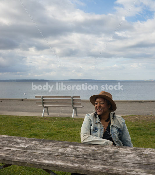 Plus-Size African American Woman Outdoors Relaxing at Picnic Table - Body Liberation Photos