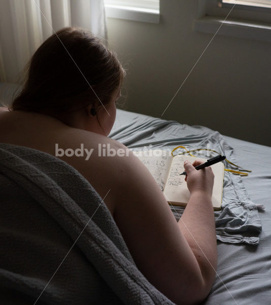 Self Care Stock Photo: Plus-Size Woman Writing and Journaling in Bed - Body Liberation Photos