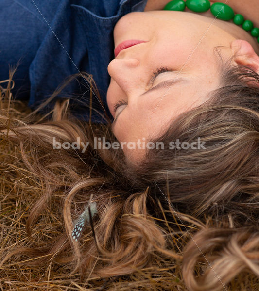 Stock Image: Plus-Size Woman with Feathers in Grass - Body Liberation Photos