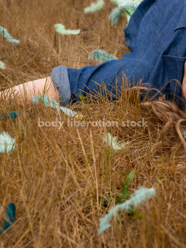 Stock Image: Plus-Size Woman with Feathers in Grass - Body Liberation Photos