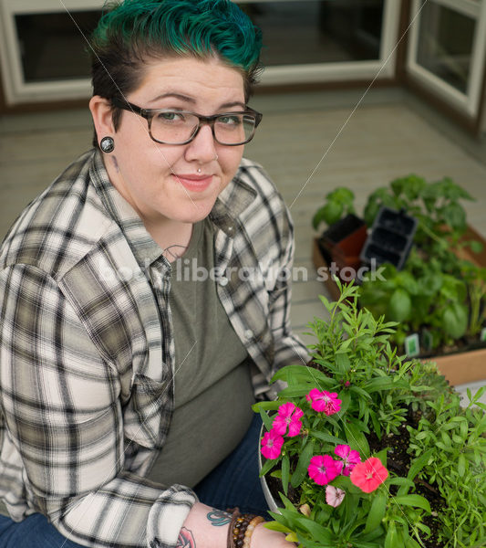 Stock Photo: Agender Person Chooses Plants while Gardening - Body Liberation Photos