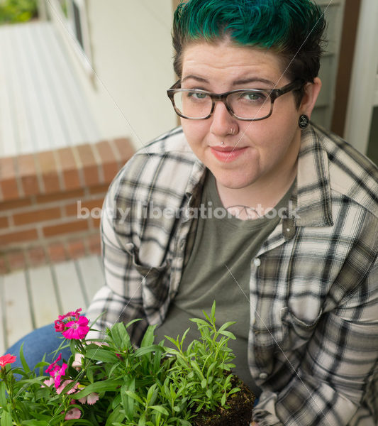 Stock Photo: Agender Person Chooses Plants while Gardening - Body Liberation Photos