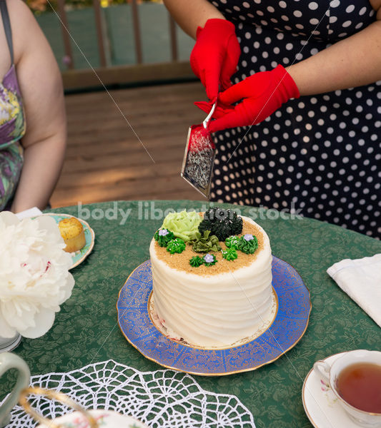 Woman Cuts Cake at Tea Party - Body Liberation Photos