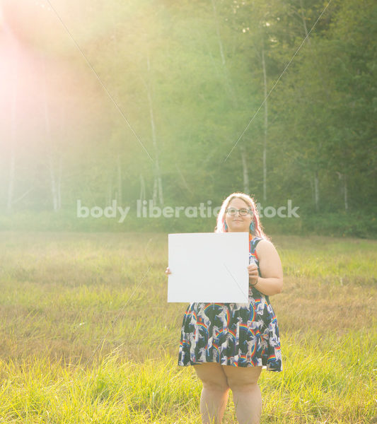 Blank Sign Stock Image: Woman in Field with Sign, Ready for Copy - Body Liberation Photos