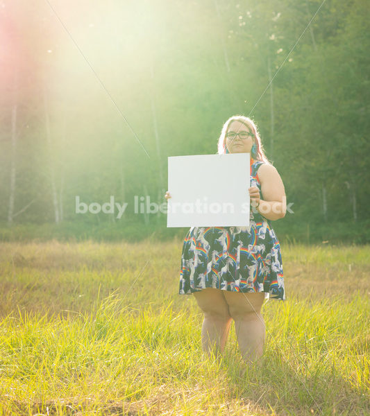 Blank Sign Stock Image: Woman in Field with Sign, Ready for Copy - Body Liberation Photos