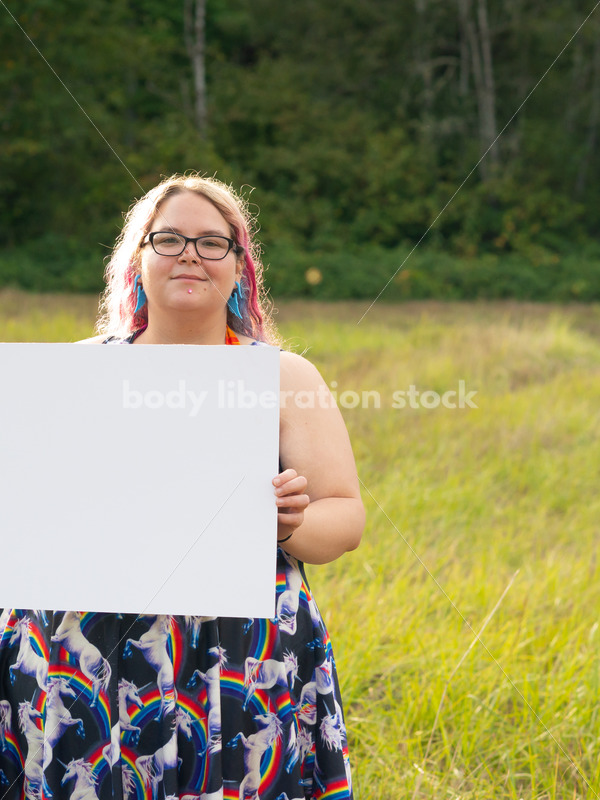 Blank Sign Stock Image: Woman in Field with Sign, Ready for Copy - Body Liberation Photos