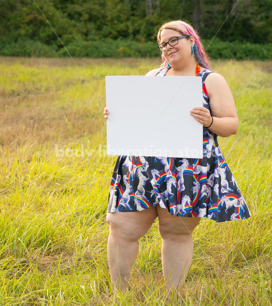 Blank Sign Stock Image: Woman in Field with Sign, Ready for Copy - Body Liberation Photos