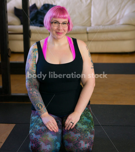 HAES Stock Photo: Female Weightlifter with Pink Hair Kneels in Weight Lifting Gym - Body Liberation Photos