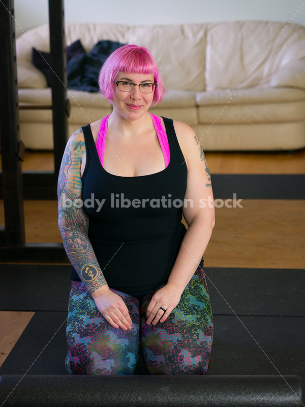 HAES Stock Photo: Female Weightlifter with Pink Hair Kneels in Weight Lifting Gym - Body Liberation Photos