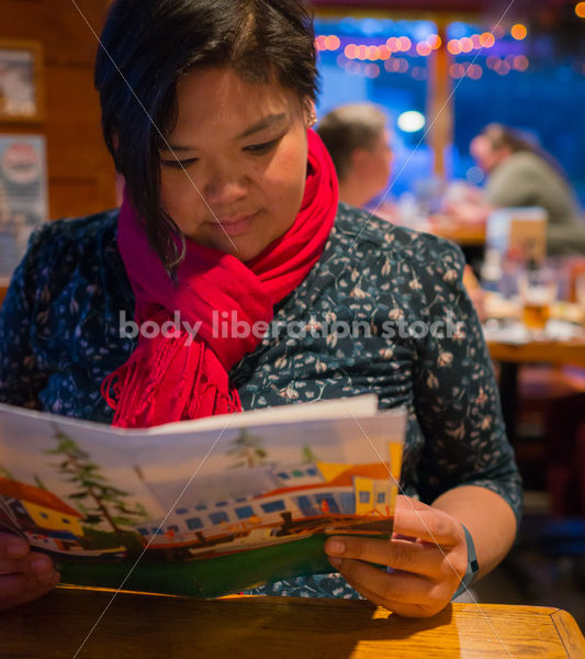 Stock Photo: Intuitive Eating – Asian American Woman with Menu - Body Liberation Photos