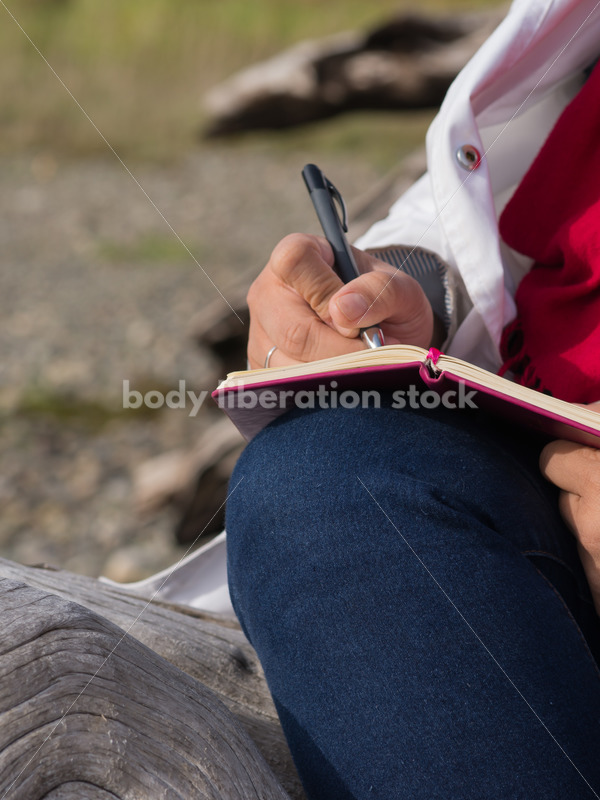 Stock Photo: Young Asian American Woman Writing in Journal Outdoors - Body Liberation Photos