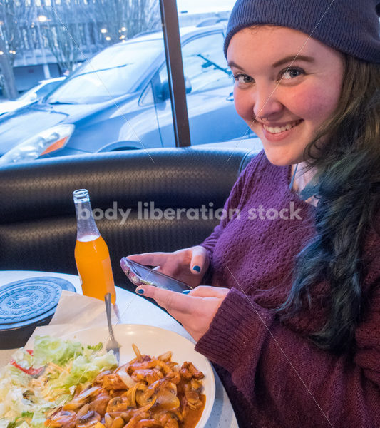 Young Plus Size Woman Enjoying Mexican Food, Wearing Blue Stocking Hat and Purple Sweater - Body Liberation Photos