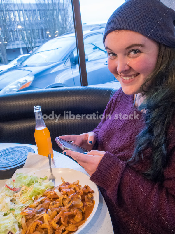 Young Plus Size Woman Enjoying Mexican Food, Wearing Blue Stocking Hat and Purple Sweater - Body Liberation Photos