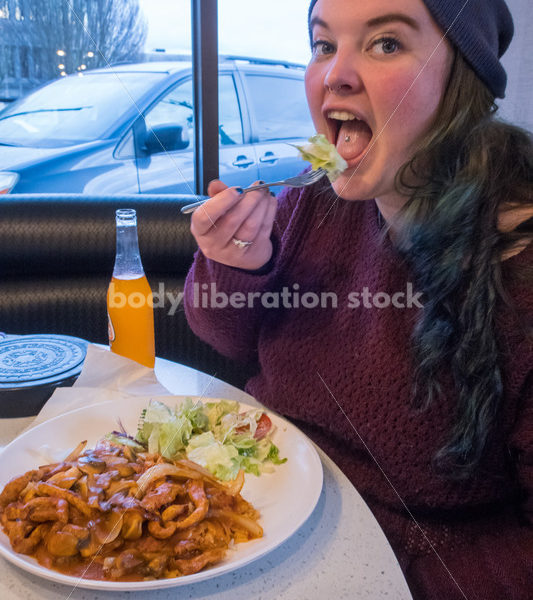 Young Plus Size Woman Enjoying Mexican Food, Wearing Blue Stocking Hat and Purple Sweater - Body Liberation Photos