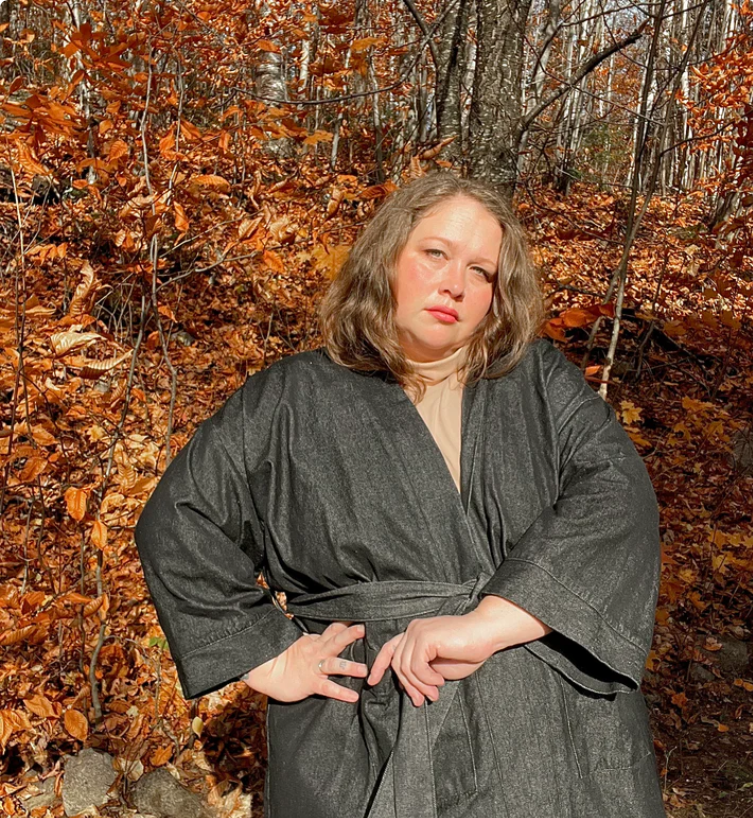 A fat woman wearing a gray denim robe