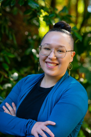 A woman smiles confidently at the camera for a business headshot in WA