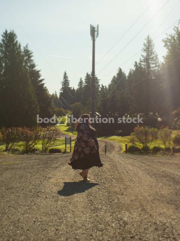 Inclusive Stock Photo: Plus-Size Woman Twirls on Gravel Road - Body liberation boudoir, portraits, stock, HAES & more | Seattle