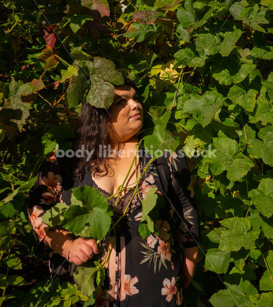 Size-Diverse Stock Photo: Woman Partially Hidden in Vines - Body liberation boudoir, portraits, stock, HAES & more | Seattle