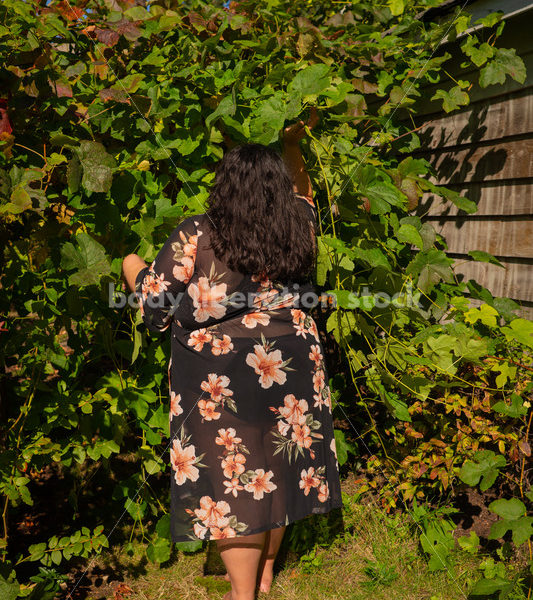 Size-Diverse Stock Photo: Woman Partially Hidden in Vines - Body liberation boudoir, portraits, stock, HAES & more | Seattle