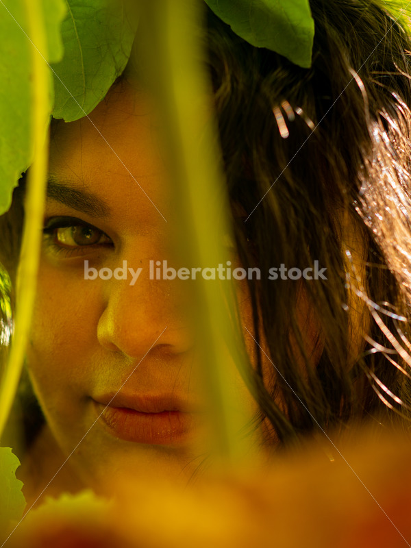 Size-Diverse Stock Photo: Woman Smiling Through Vines - Body liberation boudoir, portraits, stock, HAES & more | Seattle