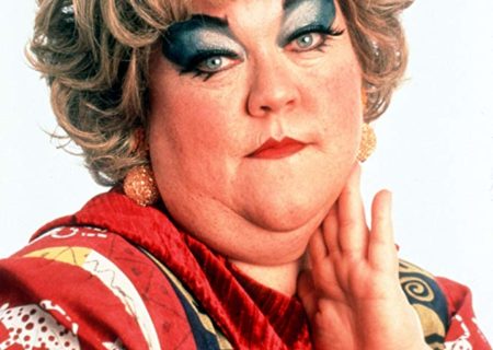 Mimi from the Drew Carey Show, a fat woman who is seen with a great deal of fatphobia and weight stigma. She's a fat woman wearing clown-like makeup and posing coyly.