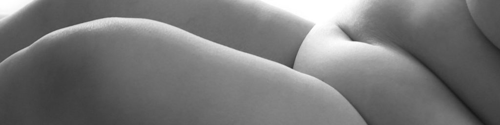 A fat woman's stomach and legs in black and white